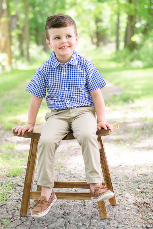 Model is sat on a chair outside wearing Apple of my Eye Button Down. Paired with khaki pants and moccasins (not included in purchase).